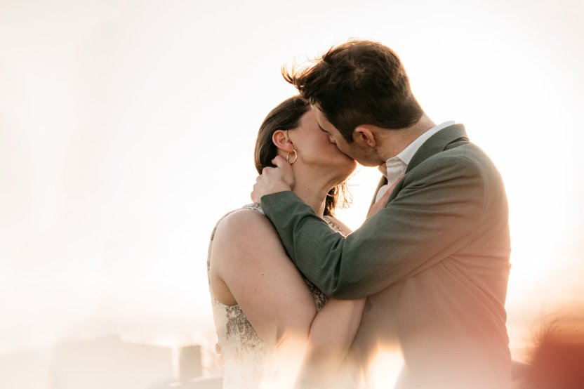 Tim and Hanna kiss at golden hour